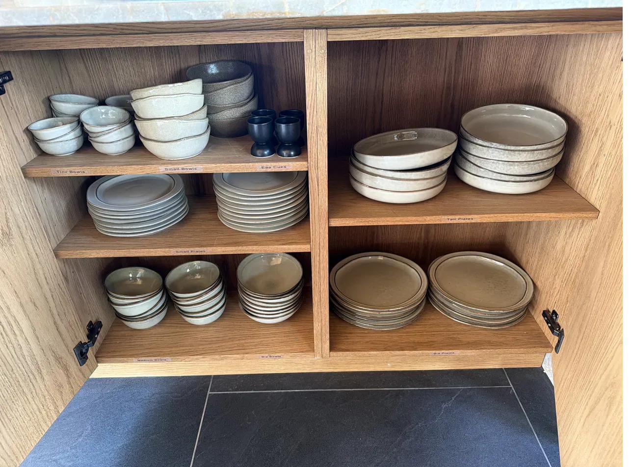 Plates and bowls cupboard in The Nest kitchen