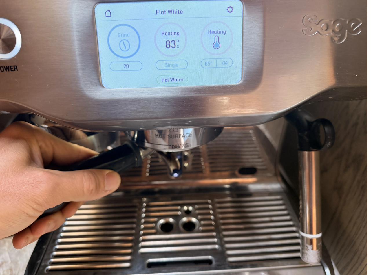 Portafilter locked into the group head, brewing status screen